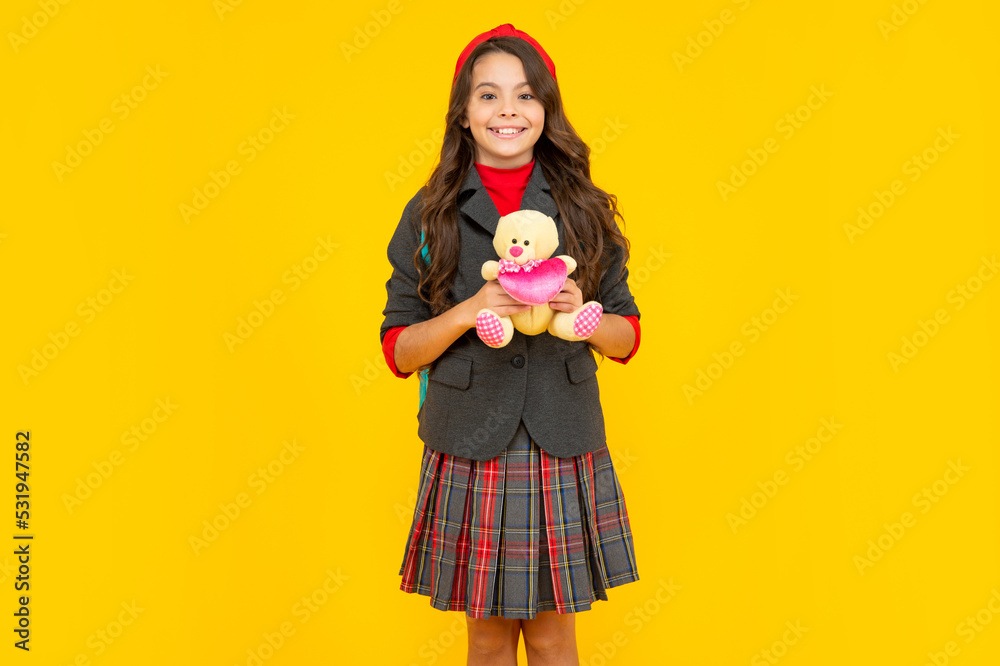 cheerful child in school uniform with toy on yellow background, school cheerful child in school uniform with toy on yellow background, school
