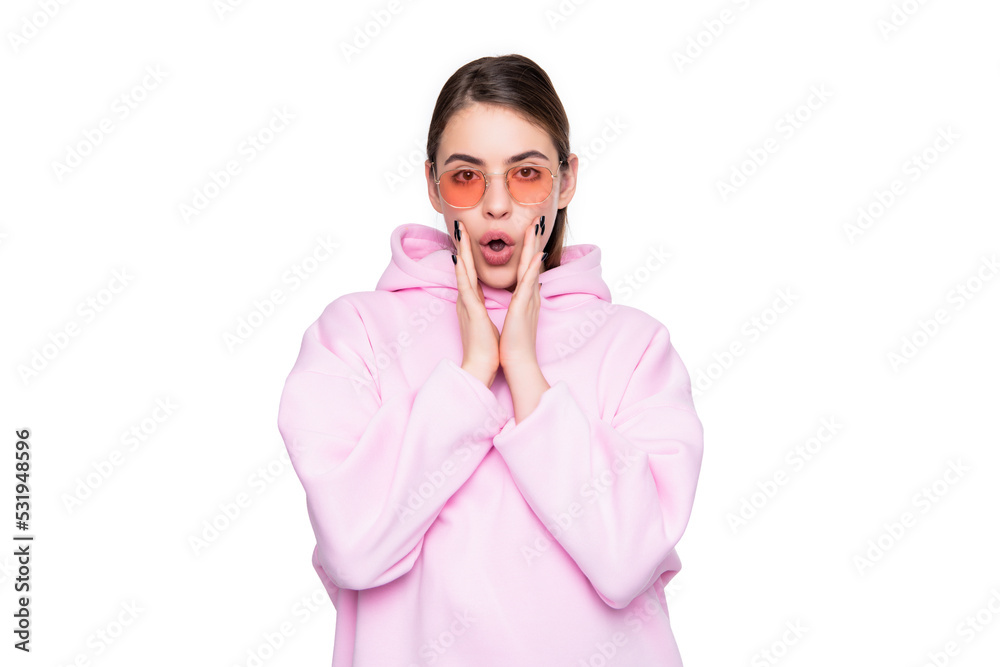 Surprised girl in casual pink hoodie and glasses shouting wow keeping hands at open mouth Surprised girl in casual pink hoodie and glasses shouting wow keeping hands at open mouth