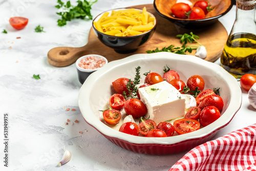 Trend Feta pasta recipe made of cherry tomatoes, feta cheese, garlic and herbs. cooking recipe ingredients, place for text, top view