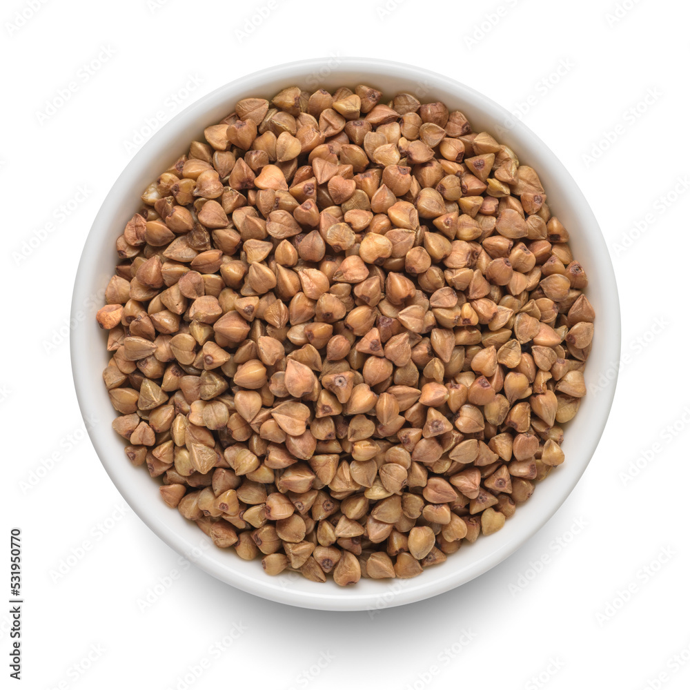 Raw buckwheat in white bowl isolated on white. Top view. Raw buckwheat in white bowl isolated on white. Top view.