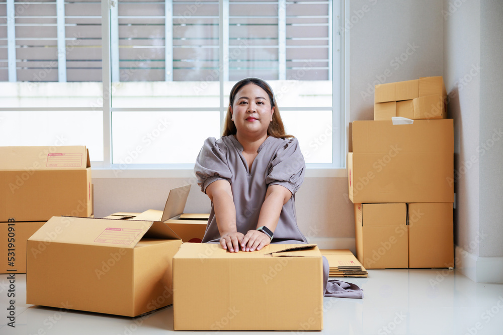 Asian woman startup packaging business, holding parcel box, order by online at her home. Asian woman startup packaging business, holding parcel box, order by online at her home.