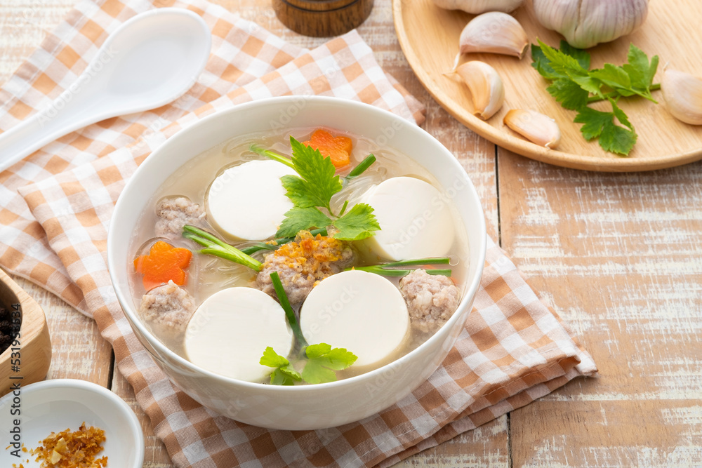 Clear soup with soy bean curd ,Minced Pork and Vegetables in white bowl Clear soup with soy bean curd ,Minced Pork and Vegetables in white bowl