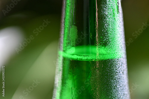 Closeupd of cold green wine bottle with water drops  photo