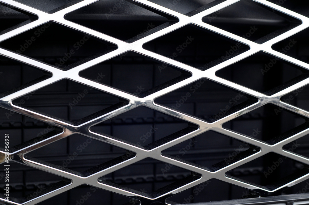 Chrome-plated radiator grille of a modern car close-up.