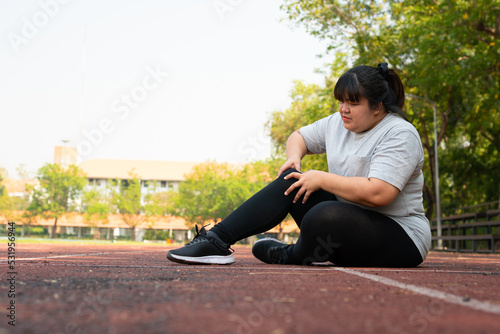 Asian overweight woman a new runner pain ankle during running  Athlete runner training accident. Sport running ankle sprained sprain cause injury. weight loss  workout  sports  health care concepts