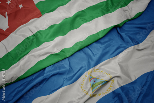 waving colorful flag of abkhazia and national flag of nicaragua. 3d illustration