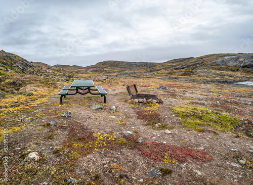 View of a picnic table and grill on the tundra at Sylvia Grinnell Territorial Park, Nunavut photo