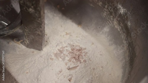 Chef pours the dry yeast into the flour
