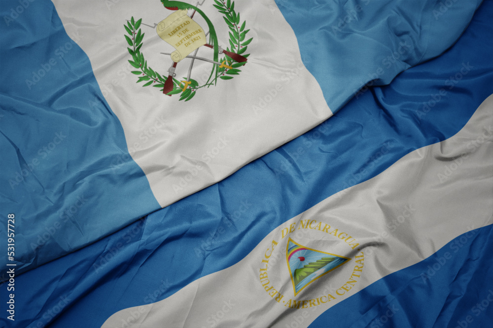 waving colorful flag of guatemala and national flag of nicaragua. 3d illustration