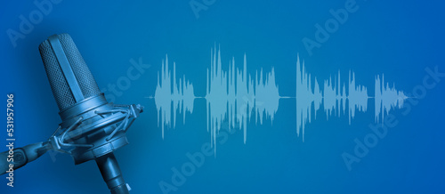 Blue microphone with audio waveform on blue background, recording studio, broadcasting or podcasting banner