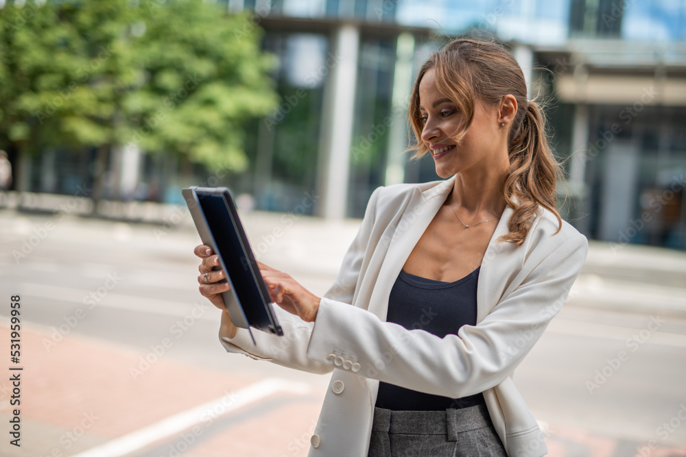 Businesswoman using a digital tablet outdoor Businesswoman using a digital tablet outdoor