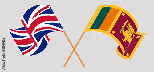 Crossed and waving flags of United Kingdom and Sri Lanka