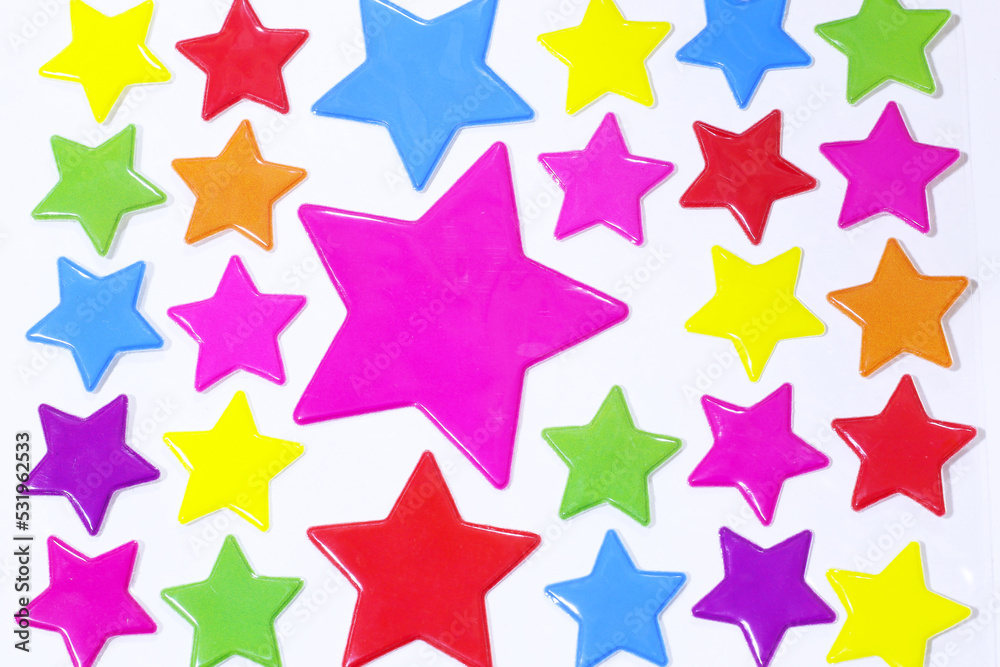 Multi-colored star stickers are pasted onto white handmade paper. Multi-colored star stickers are pasted onto white handmade paper.