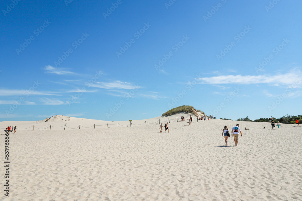 Rippled sand background, dune and see in Slowinski National Park, Leba, Poland. Beautiful scenery of sand dunes and ocean. Rippled sand background, dune and see in Slowinski National Park, Leba, Poland. Beautiful scenery of sand dunes and ocean.