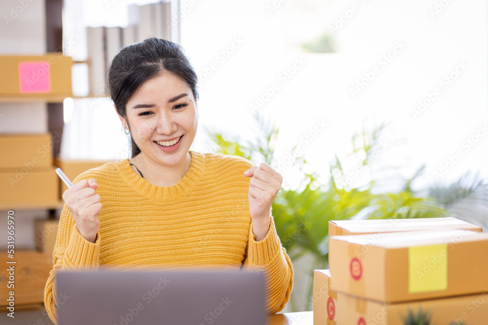 Business Asian women working on laptop computer checking customer order online shipping box at home. Starting Small business entrepreneur SME freelance. Online business, Work at home SME concept. Business Asian women working on laptop computer checking customer order online shipping box at home. Starting Small business entrepreneur SME freelance. Online business, Work at home SME concept.