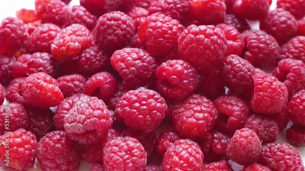 A lot of ripe red sweet delicious raspberries are on the table. The concept of healthy nutrition, vitamins, berries for breakfast, vitamin sweet snack A lot of ripe red sweet delicious raspberries are on the table. The concept of healthy nutrition, vitamins, berries for breakfast, vitamin sweet snack