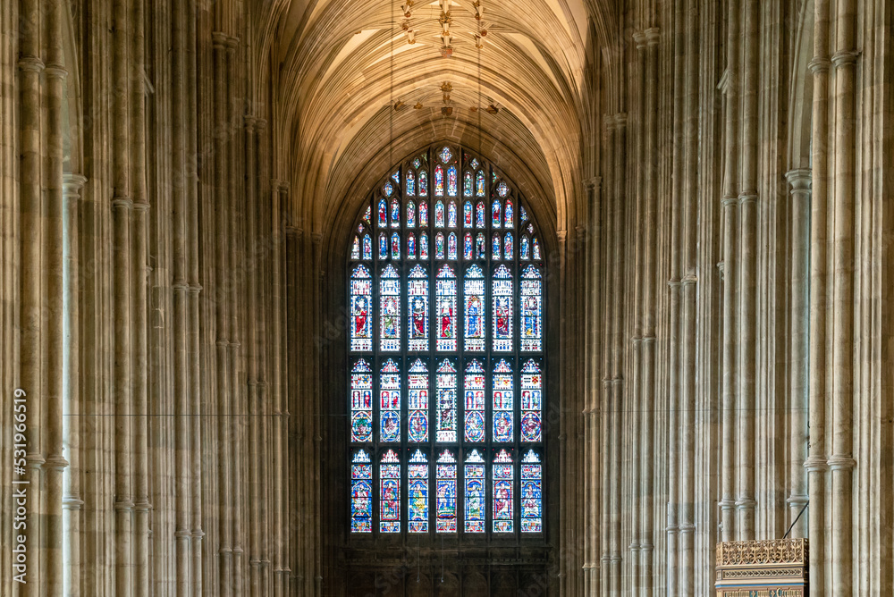stained glass window and Gothic architecture columns of the central nave inside the historic Canterbury Cathedral