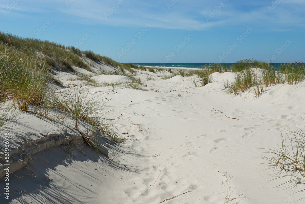 Rippled sand background, dune and see in Slowinski National Park, Leba, Poland. Beautiful scenery of sand dunes and ocean. Rippled sand background, dune and see in Slowinski National Park, Leba, Poland. Beautiful scenery of sand dunes and ocean.