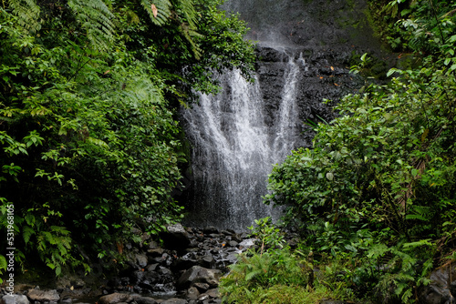 Stunning cascading waterfall falling over rocky cliff face deep in the jungle of Pohnpei, Federated States of Micronesia