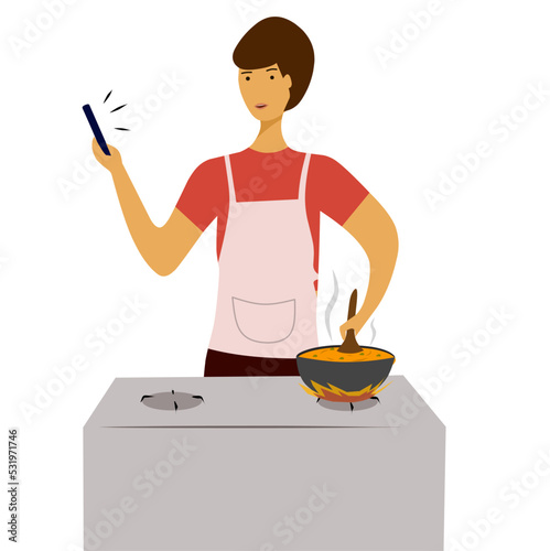 Man cooking in the kitchen while looking at his phone