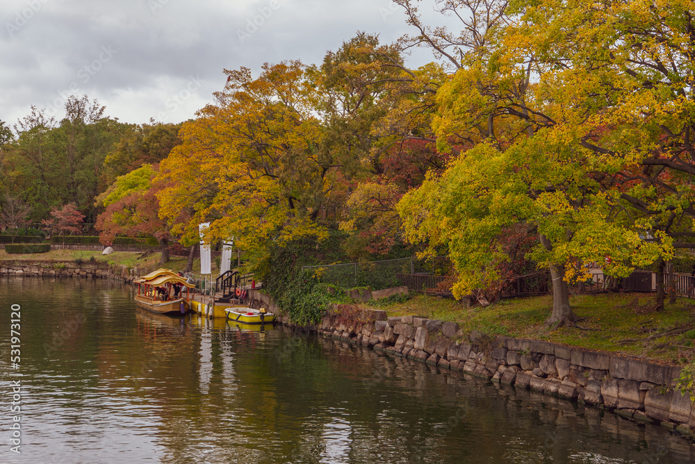 Fototapeta premium Boat cruise at Osaka Castle Complex in autumn season in Osaka, Japan.