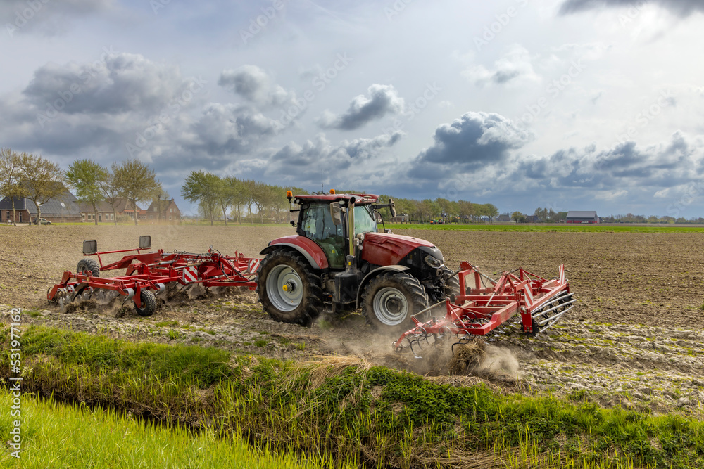 Tractor during spring work on the field Tractor during spring work on the field