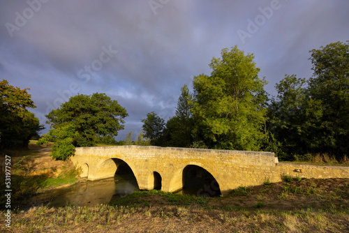 Romanesque bridge of Artigue and river Osse near Larressingle on route to Santiago de Compostela, UNESCO World Heritage Site, departement Gers, France photo