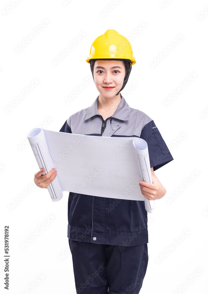 A female worker in a hard hat and a uniform carrying a drawing A female worker in a hard hat and a uniform carrying a drawing