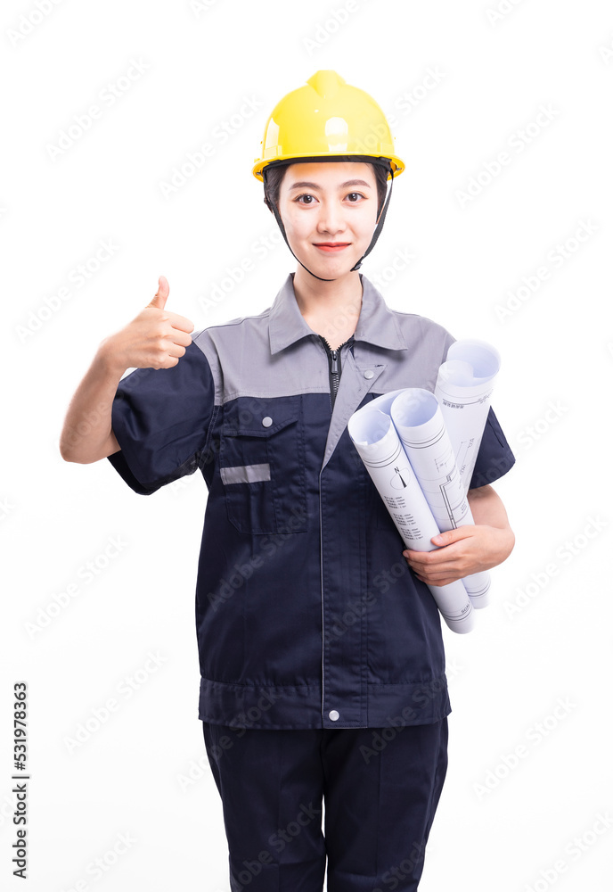 A female worker in a hard hat and a uniform carrying a drawing A female worker in a hard hat and a uniform carrying a drawing
