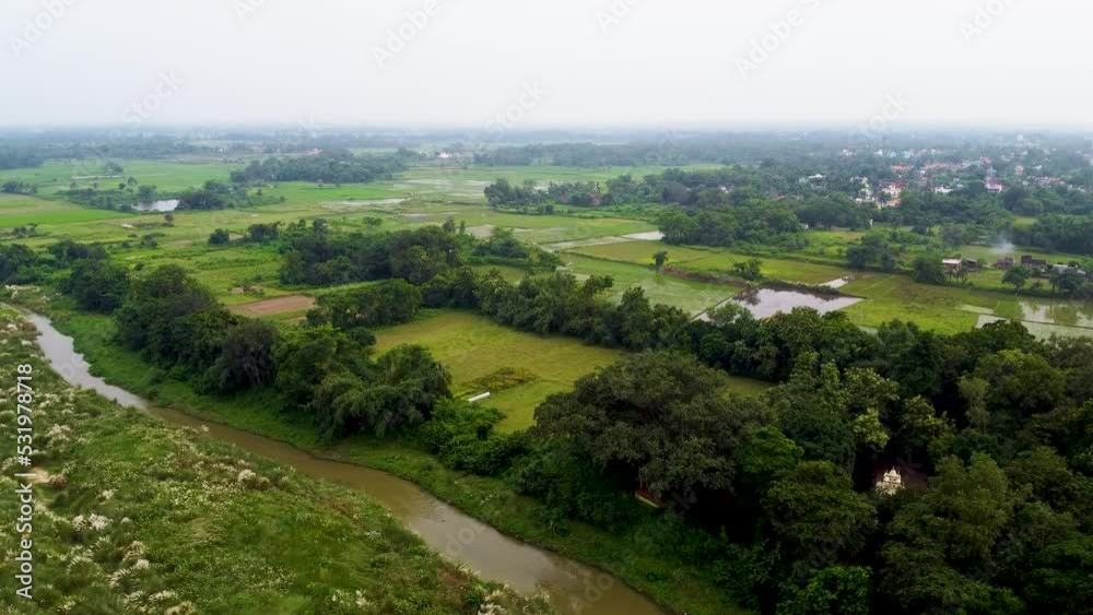 Aerial view of river and farms, drone video in India, farms and fields in Indian village with river. Aerial view of river and farms, drone video in India, farms and fields in Indian village with river.