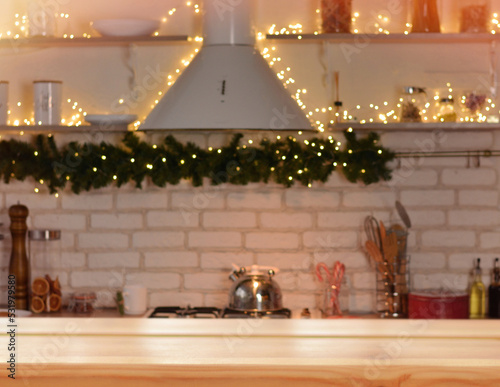 Christmas background. Empty wooden table on the background of the Christmas kitchen  New Year s golden bokeh.Ready for product montage. Copy space