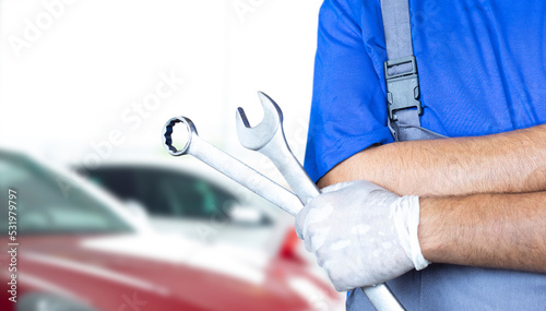 repairman holding tools at auto service