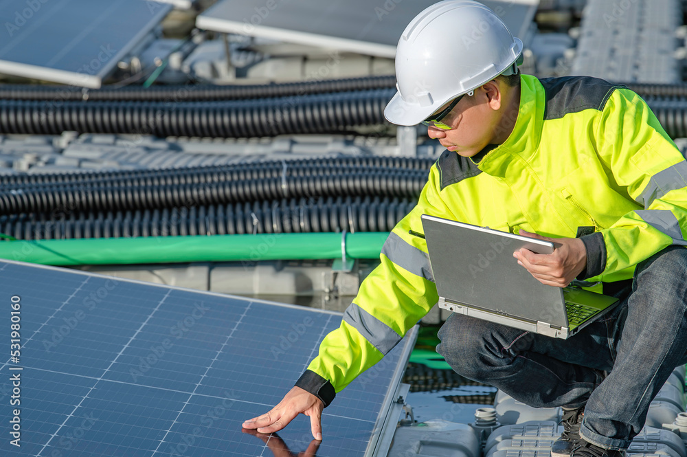 Asian engineer working at Floating solar power plant,Renewable energy,Technician and investor solar panels checking the panels at solar energy installation Asian engineer working at Floating solar power plant,Renewable energy,Technician and investor solar panels checking the panels at solar energy installation
