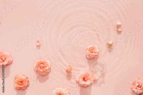 Pink aquatic, transparent water texture with ripples and drops and pink flowers. Water background
