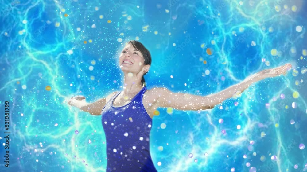 Cinemagraph of young woman spreading her arms with blue glitter background