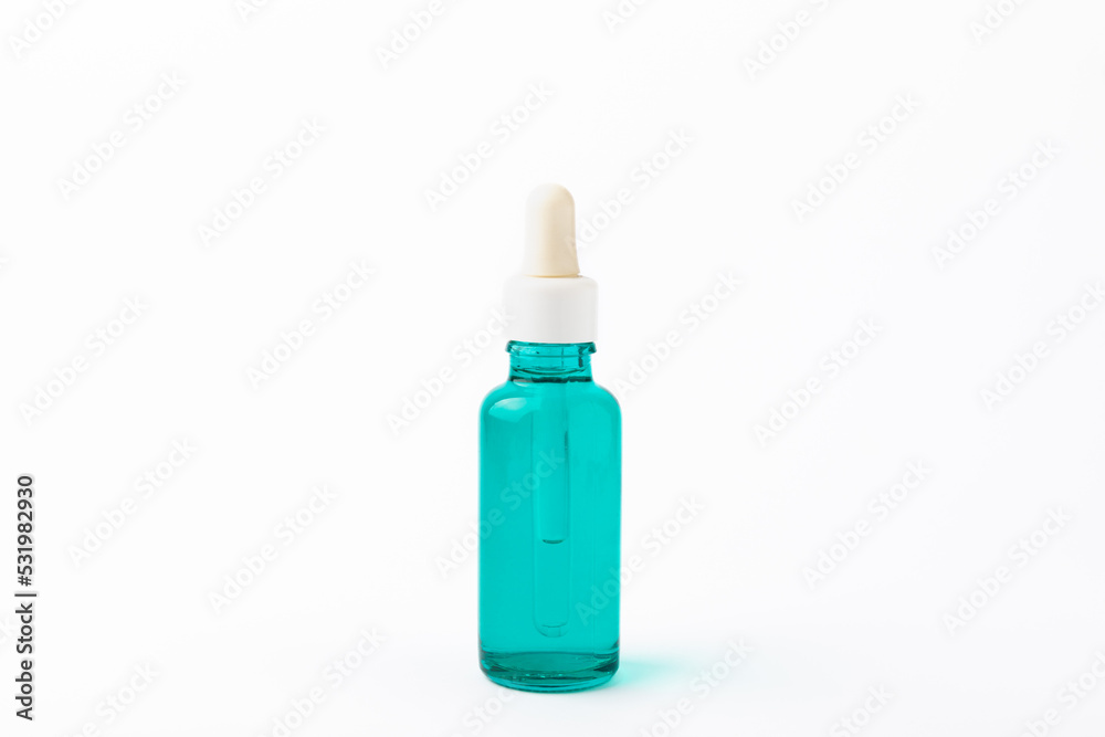 Essential oil in a glass bottle with a pipette. A bottle of scented oil. isolated on a white background. essential oil mockup with copy space. serum. Essential oil in a glass bottle with a pipette. A bottle of scented oil. isolated on a white background. essential oil mockup with copy space. serum.