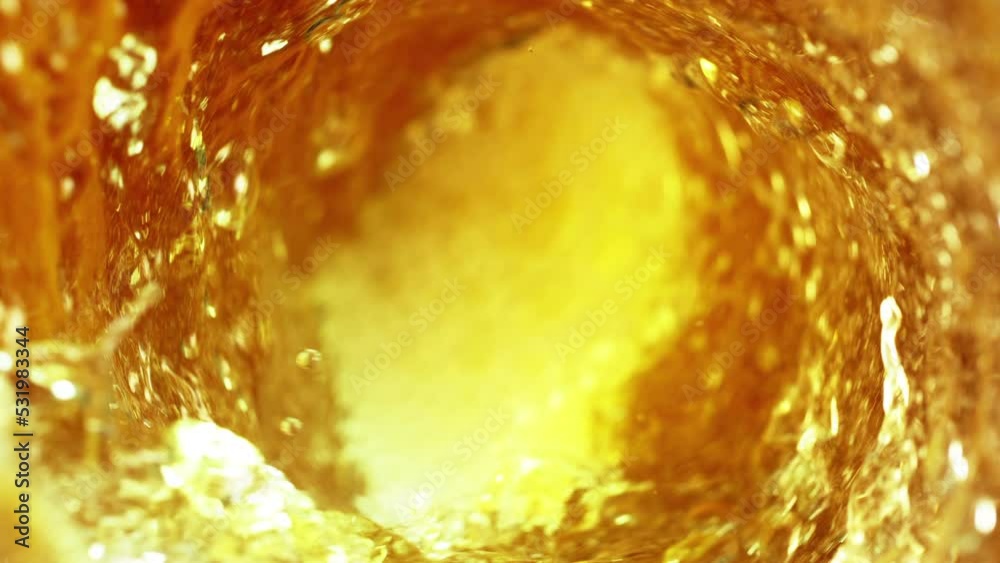 Super slow motion of pouring oil, cola or spirit drink in twister shape. Filmed on high speed cinema camera, 1000 fps. Speed ramp effect.