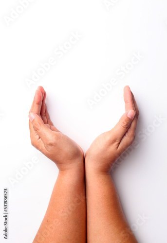 Close up photo of woman's hand holding something over white background with copyspace