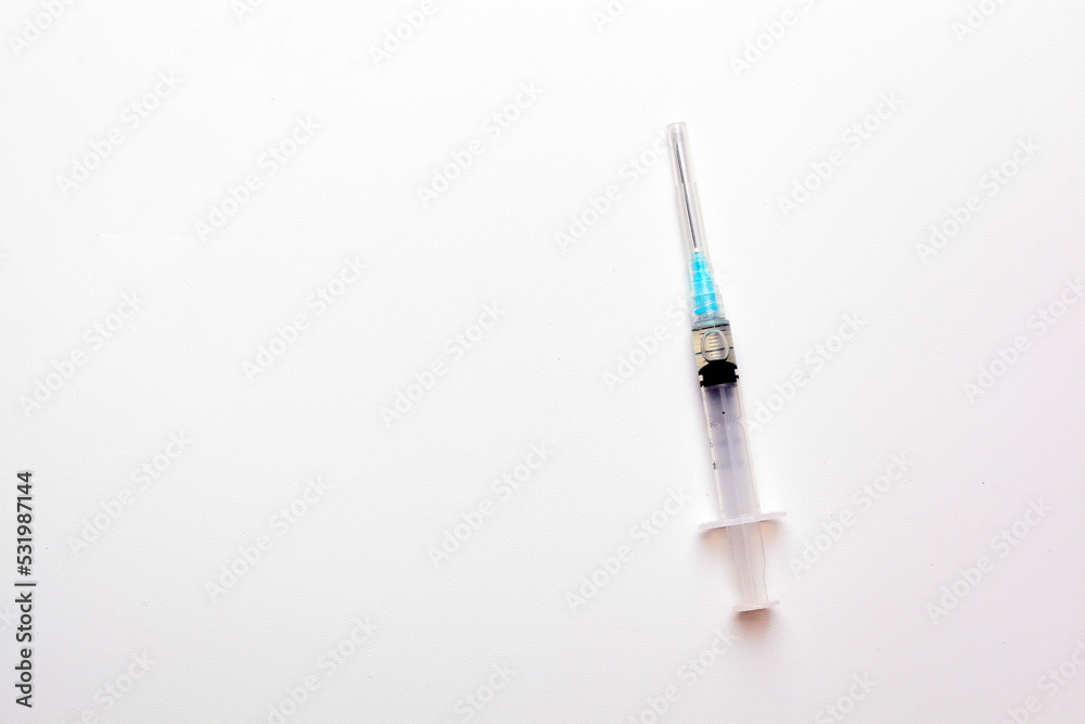Medical syringe over white background with copyspace Medical syringe over white background with copyspace