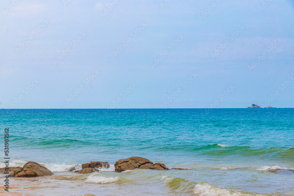 Naithon Beach bay turquoise clear water and waves Phuket Thailand.