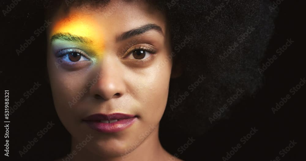 Black woman, rainbow light and lgbtq pride on dark studio background with fashion hair and lipstick makeup cosmetics. Zoom face portrait of power, freedom or human rights for beauty model or equality Black woman, rainbow light and lgbtq pride on dark studio background with fashion hair and lipstick makeup cosmetics. Zoom face portrait of power, freedom or human rights for beauty model or equality