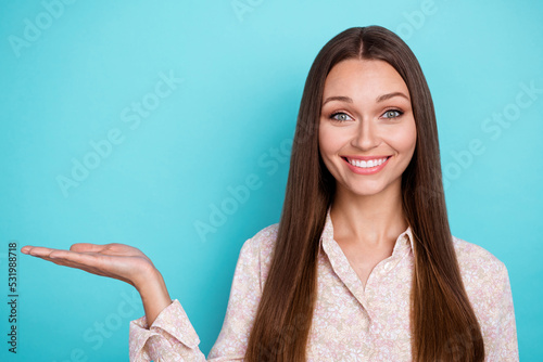 Photo of pretty positive lady bright shiny grin arm direct empty space cool proposition shopping sale isolated on cyan color background