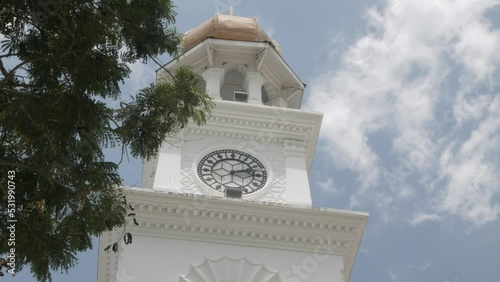 lower view up to the colonial ancient european architecture clock tower in georgetown, penang with clear blue sky in summer day photo