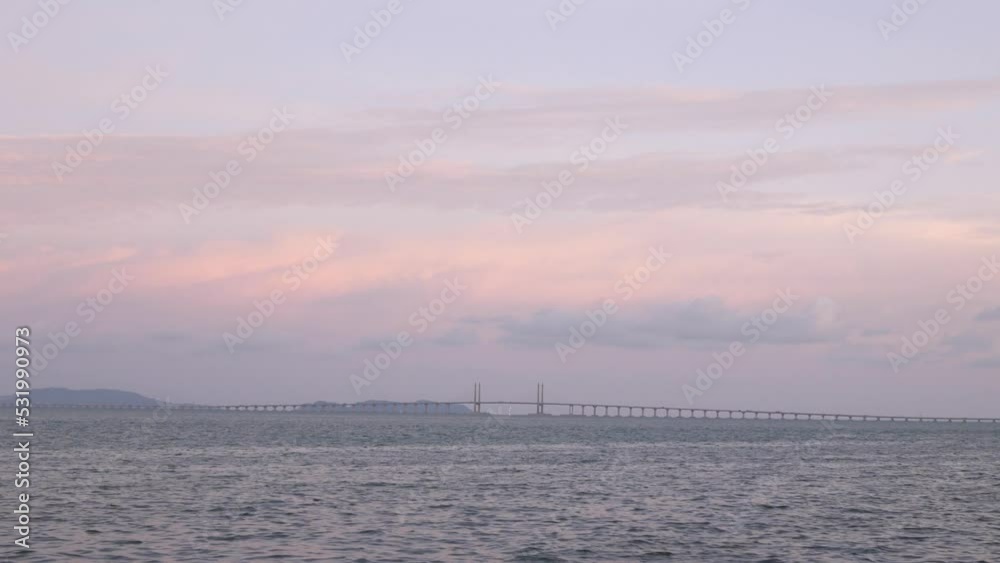 landscape view of the penang bridge over sea with car traffic move at highway from the park near sea coast landscape view of the penang bridge over sea with car traffic move at highway from the park near sea coast