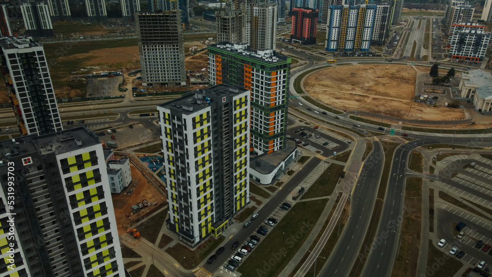 Construction site of a new city block. Construction of multi-storey buildings. Overcast weather. Aerial photography. Construction site of a new city block. Construction of multi-storey buildings. Overcast weather. Aerial photography.