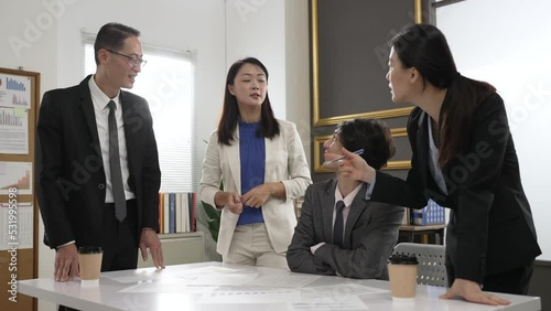 group of asian businesspeople nodding head showing agreement while listening to woman team partner’s strategy analysis in the meeting room