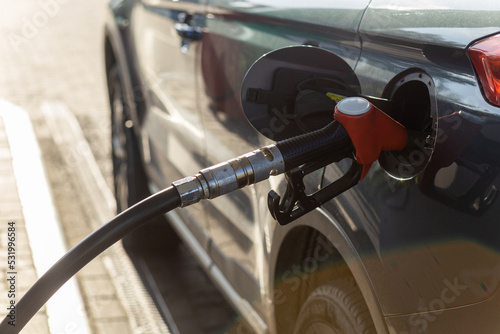 Fuel nozzle to refill fuel in car at gas station. © BY-_-BY