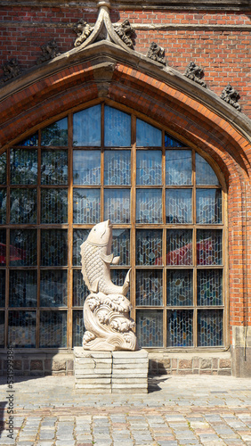 Statue or sculpture of fish in front of Rossgarten Gate, Kaliningrad, Russia. Vertical image photo