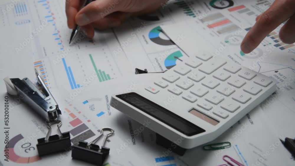 The white calculator is close and financial audit of the accountant The white calculator is close and financial audit of the accountant