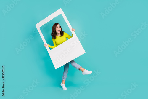 Full length photo of funny brunette hair young lady in post look promo wear shirt jeans shoes isolated on teal color background